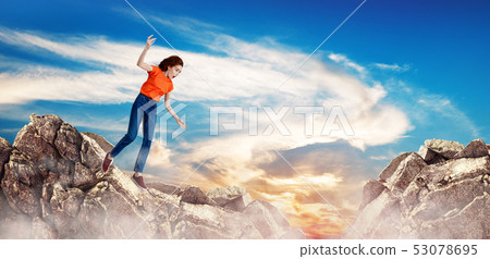 Redhead woman falling down between hills on cliff. Redhead woman falling down between hills on cliff. 53078695
