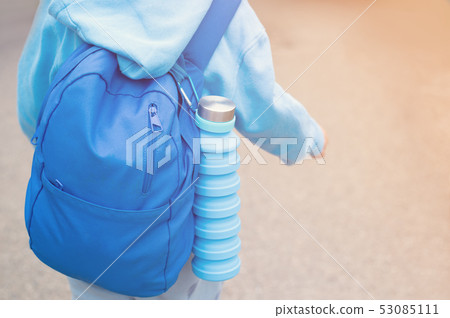 Reusable eco friendly water bottle on child's backpack Reusable eco friendly water bottle on child's backpack 53085111