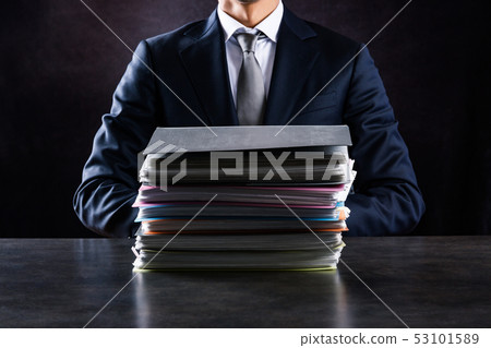 Businessman with lots of work Businessman with lots of work 53101589