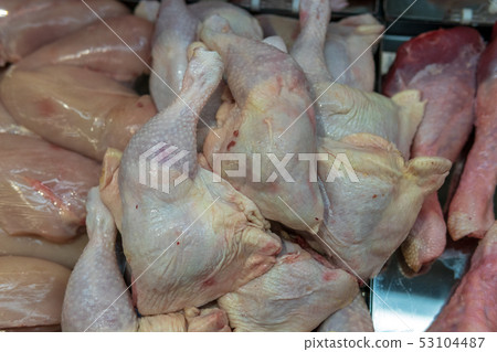 Chilled chicken thighs on a tray in a supermarket showcase Chilled chicken thighs on a tray in a supermarket showcase 53104487