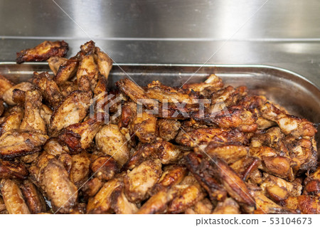Fried chicken on a tray in a supermarket showcase 53104673
