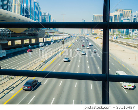 A wide multi-lane road in Dubai. View from the subway crossing. A wide multi-lane road in Dubai. View from the subway crossing. 53116487