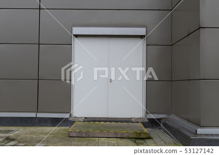 sidewalk by street wall & door sidewalk by street wall & door 53127142