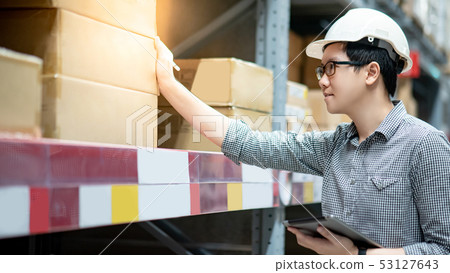 Asian man doing stocktaking on tablet in warehouse Asian man doing stocktaking on tablet in warehouse 53127643