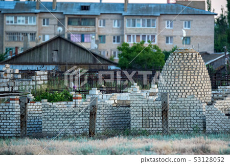 View of beautiful small Muslim graveyard outdoors with stone tombs 53128052