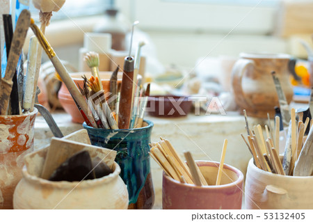 Pile of paintbrushes staying with special wooden and metal tools 53132405