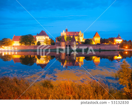 Malbork castle by night with reflection in Nogat river Malbork castle by night with reflection in Nogat river 53132830