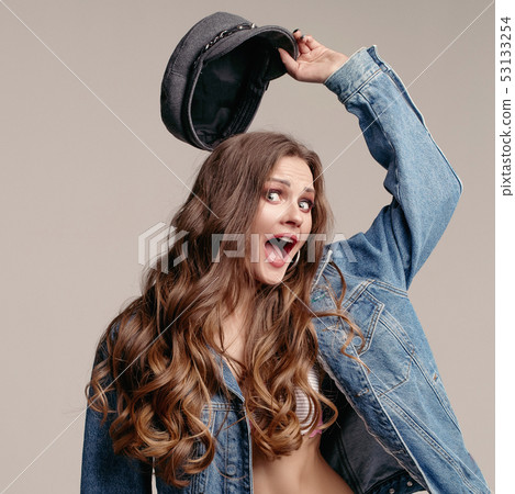 Model in underwear, denim jacket and kepi laughing Model in underwear, denim jacket and kepi laughing 53133254