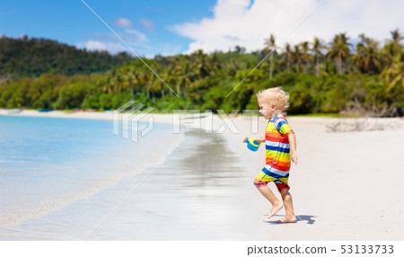 Kids play on tropical beach. Sand and water toy. Kids play on tropical beach. Sand and water toy. 53133733