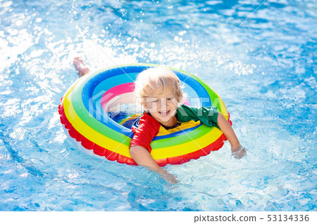 Child in swimming pool on toy ring. Kids swim. Child in swimming pool on toy ring. Kids swim. 53134336