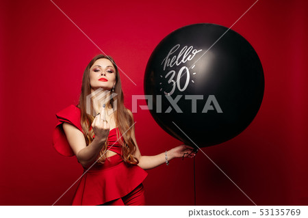 Arrogant lady in red dress and air balloon showing 53135769