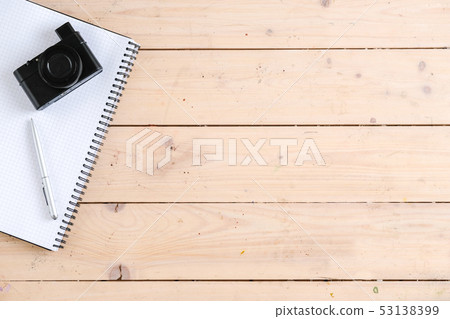 Top view of photo camera lying on the table near notebook Top view of photo camera lying on the table near notebook 53138399