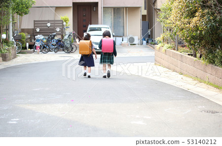 Elementary school student carrying a school bag Elementary school student carrying a school bag 53140212