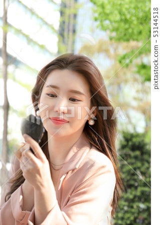 Asian model applying makeup 53144518