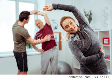 Positive joyful nice woman doing sports activities 53145117