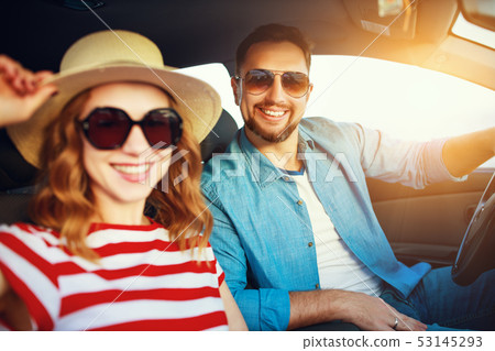 happy couple man and woman in car traveling in 53145293