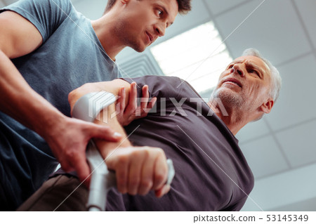 Low angle of a male nurse with his patient Low angle of a male nurse with his patient 53145349