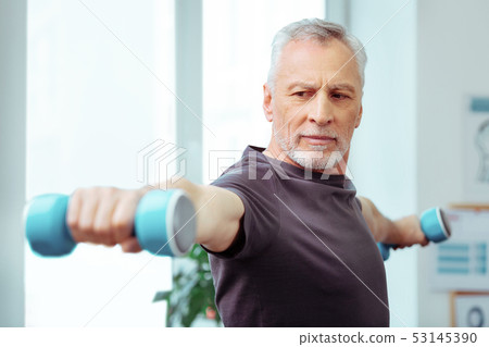 Strong well built man enjoying his training 53145390
