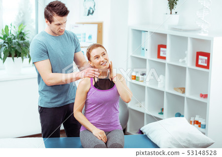 Nice serious man doing a professional neck massage Nice serious man doing a professional neck massage 53148528