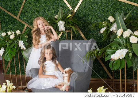 Little cute girls with blond hair in a white dress 53149593