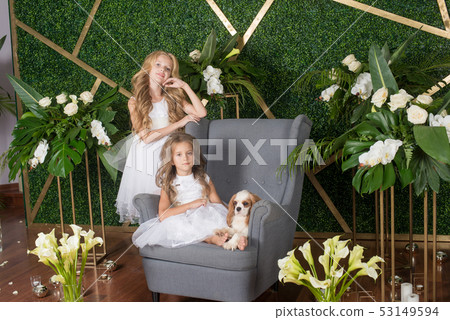 Little cute girls with blond hair in a white dress 53149594