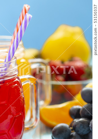 The two cups with orange juice and strawberries on The two cups with orange juice and strawberries on 53150337