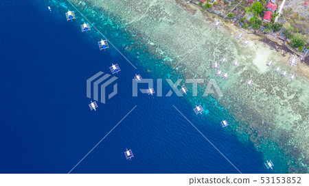 Aerial view of Filipino boats floating on sea. 53153852
