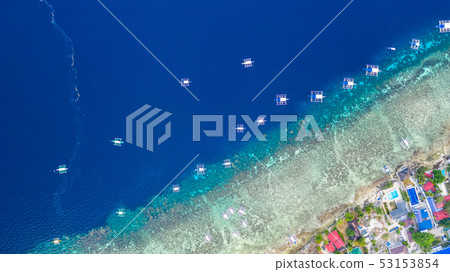 Aerial view of Filipino boats floating on sea. 53153854