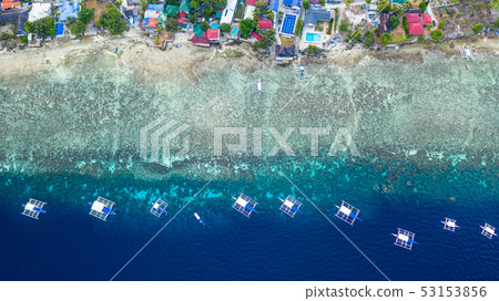Aerial view of Filipino boats floating on sea. 53153856
