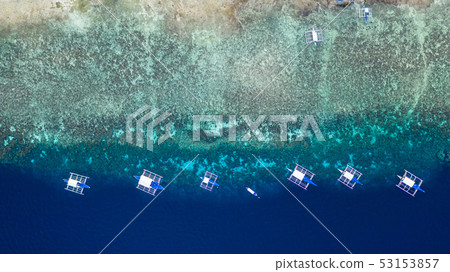 Aerial view of Filipino boats floating on sea. 53153857