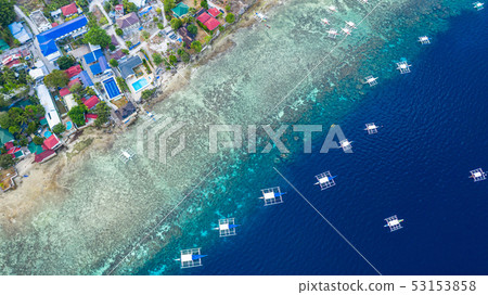 Aerial view of Filipino boats floating on sea. 53153858