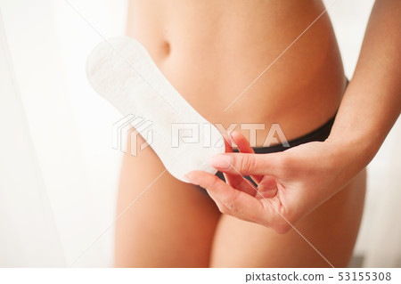 Female Hygiene. Closeup Of Beautiful Woman With Fit Slim Body In White Underwear Holding Sanitary Female Hygiene. Closeup Of Beautiful Woman With Fit Slim Body In White Underwear Holding Sanitary 53155308