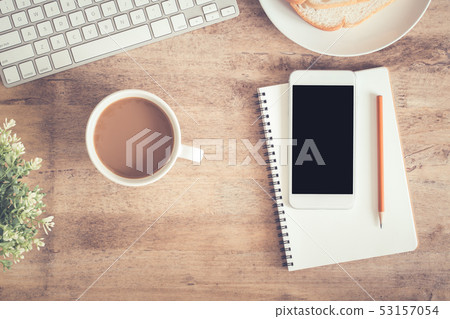 Top view of office table . On desk have notebook Top view of office table . On desk have notebook 53157054