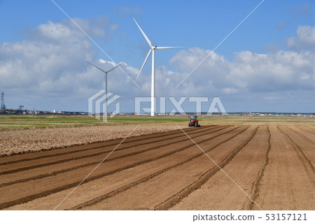 Taking a landscape of field work with a tractor in Hokkaido Atsuzawabe Town in spring Taking a landscape of field work with a tractor in Hokkaido Atsuzawabe Town in spring 53157121