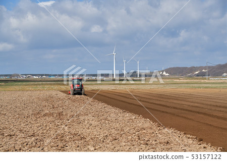 Taking a landscape of field work with a tractor in Hokkaido Atsuzawabe Town in spring 53157122