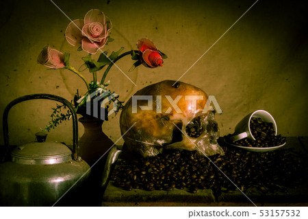 Human skull placed on coffee beans on old wood, Human skull placed on coffee beans on old wood, 53157532