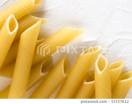 raw pasta penne on white background raw pasta penne on white background 53157612