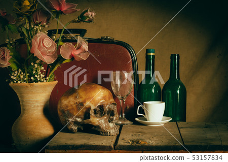 Human skull and flower vase old treasure on wooden 53157834