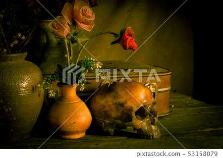 Human skull and flower vase old treasure on wooden 53158079