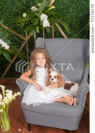 Little cute girl with blond hair in a white dress 53159178