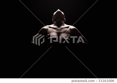 Nude Woman silhouette under light in the dark Nude Woman silhouette under light in the dark 53161006