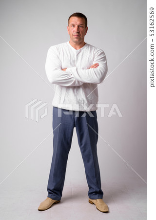 Full body shot of macho mature man with arms crossed Full body shot of macho mature man with arms crossed 53162569