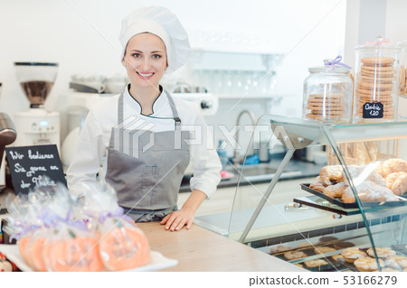 Confectioner woman in her shop selling cookies and cakes Confectioner woman in her shop selling cookies and cakes 53166279
