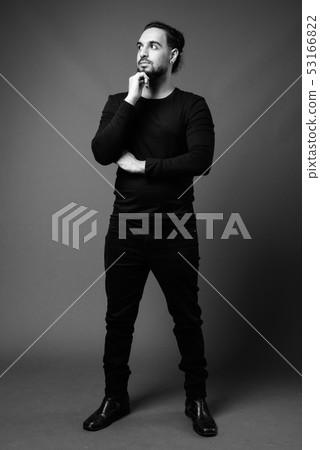 Young bearded Indian man in black and white Young bearded Indian man in black and white 53166822
