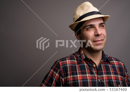 Handsome Persian tourist man ready for vacation against gray bac 53167400