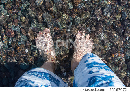 Foot transparent to the clear sea 53167672