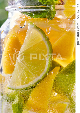 Cold refreshing water with lime and lemon in a glass. Cold refreshing water with lime and lemon in a glass. 53167953