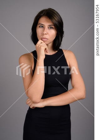 Young beautiful woman against gray background 53167954