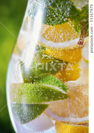 Cold mojito cocktail with fresh citrus fruit and mint in a glass. Cold mojito cocktail with fresh citrus fruit and mint in a glass. 53167979