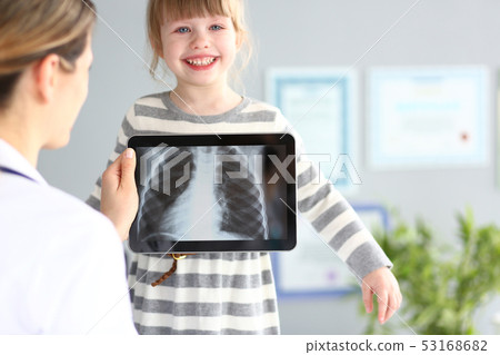 Female doctor examining little girl with ultra modern scanning tablet pc device Female doctor examining little girl with ultra modern scanning tablet pc device 53168682